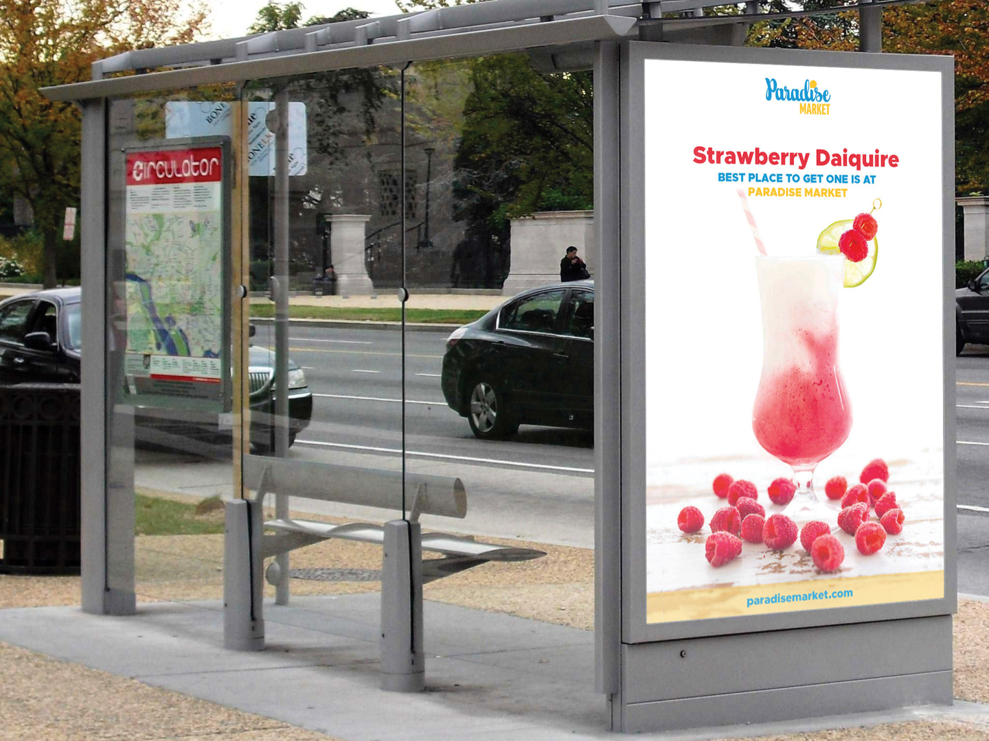 Mockup of a bus stop digital signage drawing attention to a strawberry daiquiri from Paradise Market